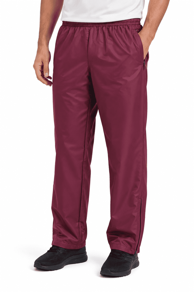 Men's track pants in burgundy, featuring an elastic waistband and side pockets. The design includes a logo on the leg.