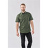 A short-sleeved, green button-up shirt with a subtle pattern, complemented by a model wearing dark jeans.