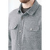 A grey unisex fleece shacket featuring a collared neckline and two chest pockets, with button detailing.