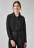 A black long sleeve shirt for women with a collared neck and button-up design. The model is wearing it with black trousers.