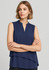 A sleeveless layered blouse in navy blue, featuring a stand-up collar and a flowing design. It has a logo.