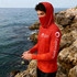 A red polyester spandex hoodie with a hood and face covering, featuring a logo on the sleeve, by Custom Sports.
