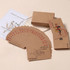 Kraft paper playing cards in earthy tones, featuring a joker and numbers in red, packaged with a floral design card.