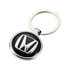 A silver keyring featuring a round black and silver embossed logo. The keyring has a smooth finish and a metal loop.