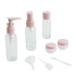 A set of clear toiletry bottles and jars with pink lids, including a pump, spray, and containers with a funnel and spatula.