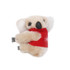 A plush toy koala with beige fur and a red shirt, featuring small black limbs and ears, holding onto a surface.