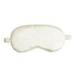 A satin sleep mask in a soft cream colour, featuring elasticated straps for comfort.