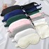 A collection of satin sleep masks in various colours, including black, green, pink, grey, and white, arranged neatly.