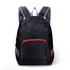 A black backpack with grey straps and a red front pocket, featuring mesh detailing and a logo.