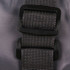 A grey travel compressed bag featuring a sturdy black buckle and strap for secure fastening.