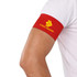A red stretchy armband on a person's arm, featuring a logo design.