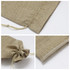 A drawstring bag in a natural beige colour, featuring a textured fabric and a simple closure. It has a logo.