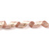 A satin ribbon in glitter gold and soft pink tones, featuring a wavy design and a logo.