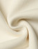 A close-up of soft, cream-coloured fabric showcasing a smooth texture and knit pattern.