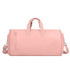 A pink convertible duffel bag with dual handles and a detachable shoulder strap, featuring a zippered pocket.