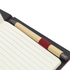 A dark notebook with lined pages and a bamboo pen with a red grip placed inside.