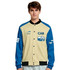 A unisex varsity jacket in beige and blue, featuring a logo and graphic designs on the sleeves.