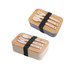 A lunch box set featuring a bamboo cover, with two colour options—blue and cream—along with wooden utensils and a strap.
