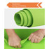 A vibrant green Premium TPE Yoga Mat rolled up, displaying its texture, with hands gripping the edge. It has a logo.