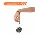 A black and grey wrist ball with a wrist strap, held by a hand, designed for leisure and outdoor activities.