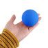 A blue bouncy ball held in a hand, with a smooth surface and no visible text or branding.