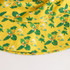 A yellow RPET bucket hat featuring a tropical leaf and floral pattern, with a logo detail.