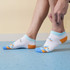 Low cut custom pattern socks in white, blue, and orange with a colourful design, featuring a logo on the side. Low cut custom pattern socks in white, blue, and orange with a colourful design, featuring a logo on the side.