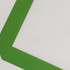 A silicone baking mat featuring a textured white surface and a green border.