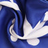 A close-up of a blue and white scarf with a patterned design, featuring a soft, textured fabric.