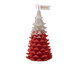 A Christmas tree shape candle in red and white, featuring a textured design and a small flag with a logo.