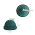 Hat-shaped candles in teal, featuring a textured knit design and a decorative white flag on top.