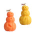 Triple pumpkin-shaped candles in orange and yellow, featuring carved pumpkin faces. Includes branding on a small flag.