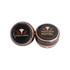 Two black tin candles with gold designs, one featuring a logo and the word "HOTEL". Two black tin candles with gold designs, one featuring a logo and the word "HOTEL".
