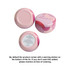A set of pink tin candles with a decorative design, featuring warning stickers on the bottoms. A set of pink tin candles with a decorative design, featuring warning stickers on the bottoms.
