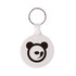 A round hard plastic keyring in white with a black bear logo and a silver keyring attachment.