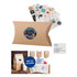 A small brown kraft pillow box featuring a round logo and assorted stickers placed behind it.