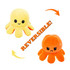 A reversible plush toy featuring a yellow, happy octopus on one side and an orange, sad octopus on the other.