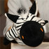 A plush zebra hand puppet in black and white with orange details and a fluffy mane. It features a friendly expression.
