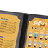 A black menu cover featuring a vibrant yellow coffee guide and a list of pastries with prices. A black menu cover featuring a vibrant yellow coffee guide and a list of pastries with prices.