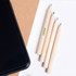 A set of four short, natural wood pencils without erasers, featured alongside a black phone on a light background.
