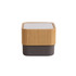 A bamboo Bluetooth wireless speaker featuring a textured wooden exterior and a dark control base.