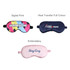 A collection of three satin sleep masks in multi-coloured, navy, and pink designs, each featuring different prints and branding.