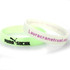 Two glow-in-the-dark silicone wristbands, one in pale green and the other white, featuring a logo on the green band. Two glow-in-the-dark silicone wristbands, one in pale green and the other white, featuring a logo on the green band.