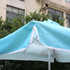 A 2x2m square patio umbrella in light blue, featuring white trim and valances, supported by a metal frame.