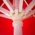 A red market umbrella featuring a white frame and detailed central pole design.