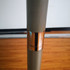 A close-up of a grey umbrella pole with a metallic copper-coloured band, showcasing its sleek design.