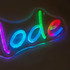 A neon LED sign featuring colourful, glowing text in various shades, displayed against a dark background.