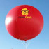 A large red inflatable advertising balloon with a logo prominently displayed on its surface, set against a blue sky.
