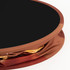 A round display counter with a black top and a fabric cover in shades of brown and gold, featuring a logo.