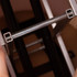 A metallic frame component of a display counter, featuring black and silver colours, with square corners and supports visible.